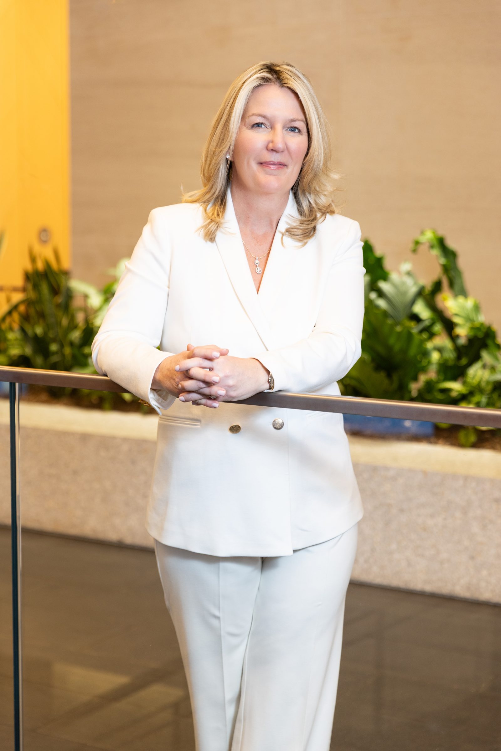 Erin Lanuti, standing in a white suit